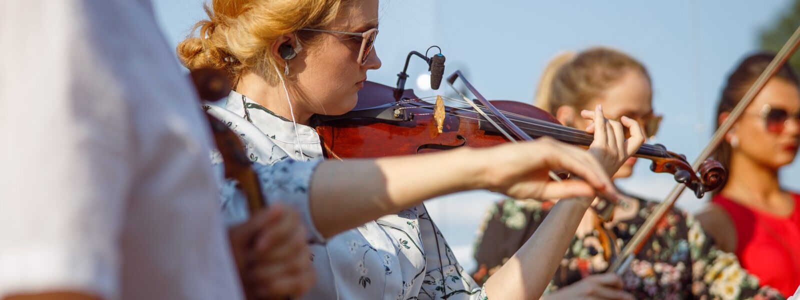 beautiful-young-woman-playing-violin-in-orchestra-2023-11-27-05-16-20-utc