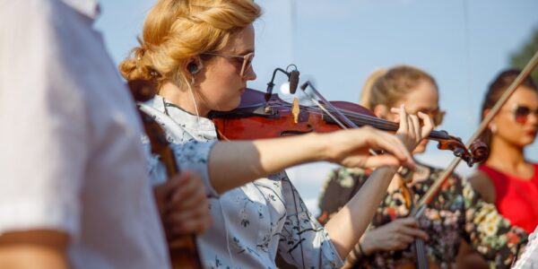 beautiful-young-woman-playing-violin-in-orchestra-2023-11-27-05-16-20-utc
